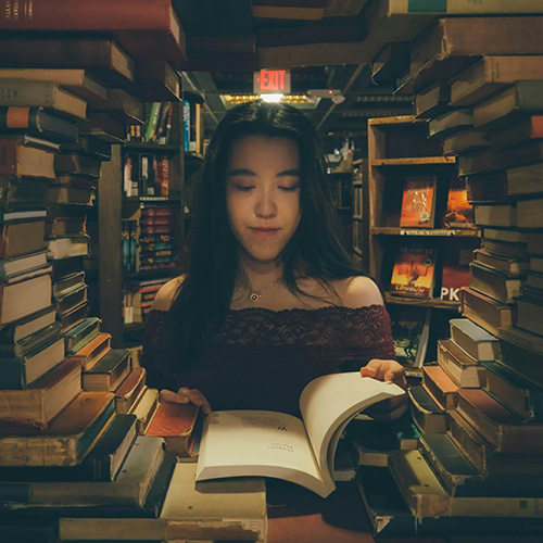 Reading framed by a circle of books