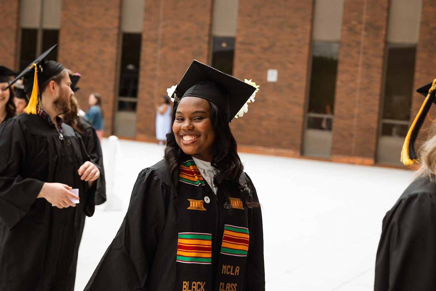 Image of a student at graduation, smiling.