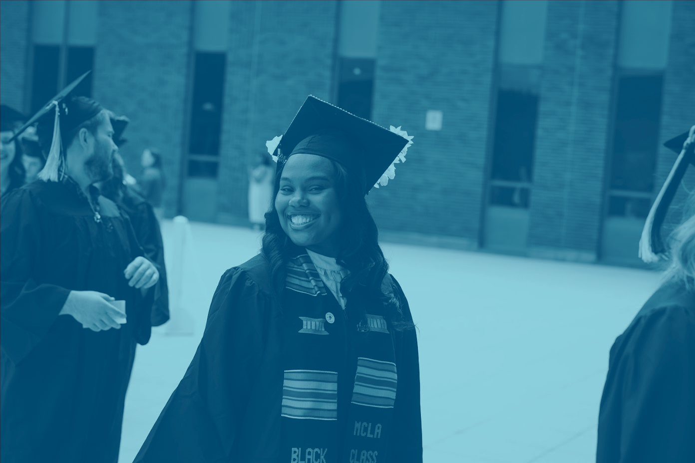 Image of a student at commencement, smiling.