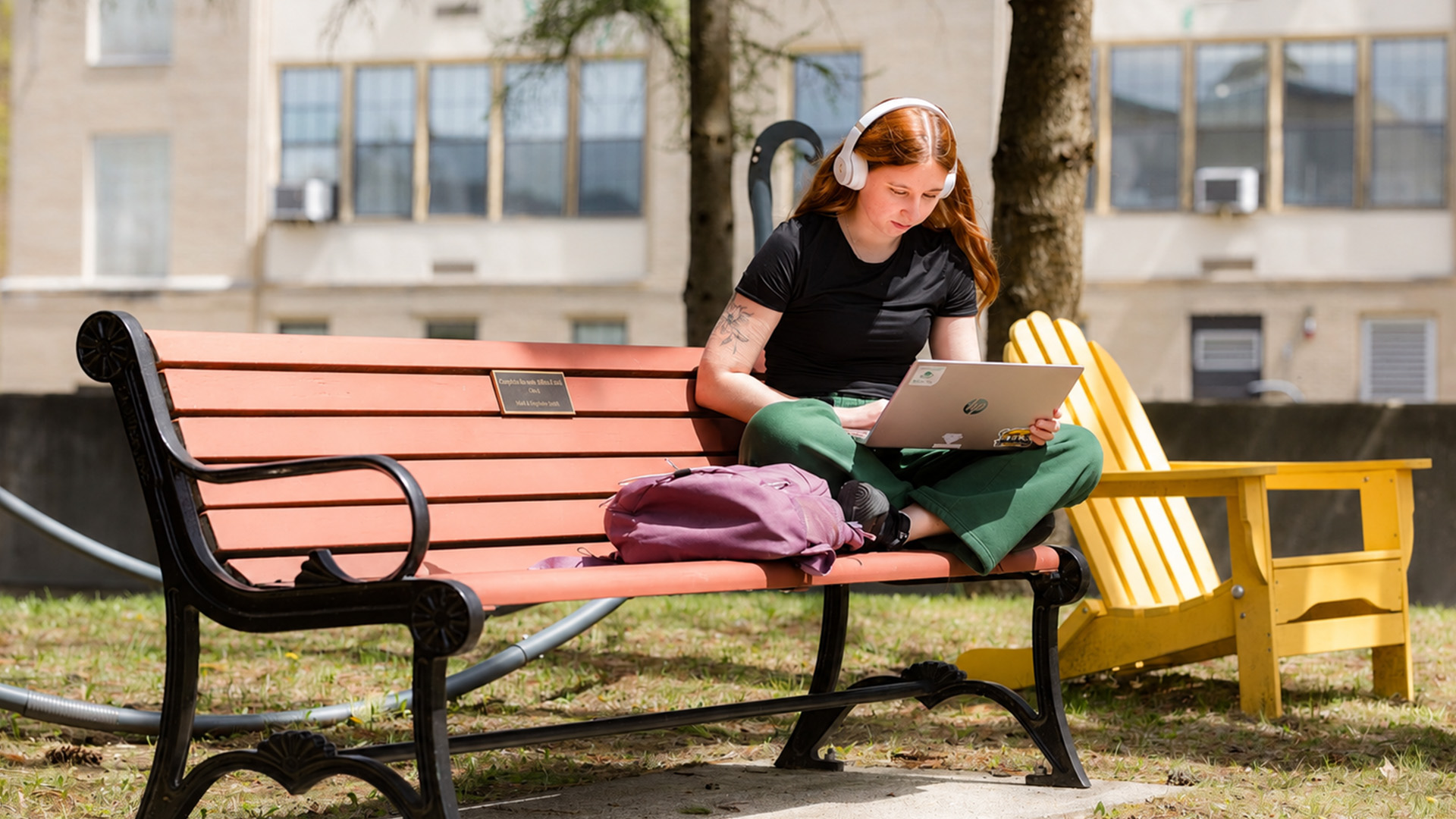 MCLA student sitting on a bench