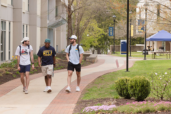 MCLA campus three students walking together